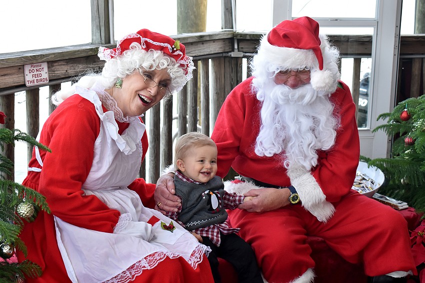 Liam Middleton smiles with Santa and Mrs. Claus