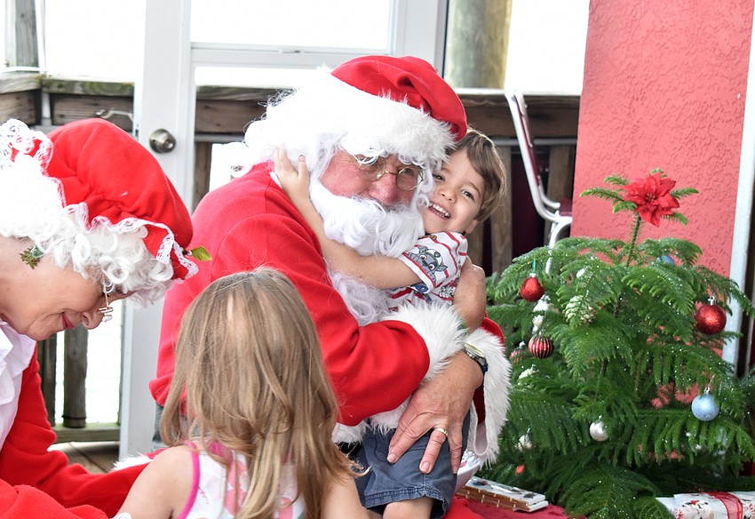 Michael Scott gives Santa a big hug.