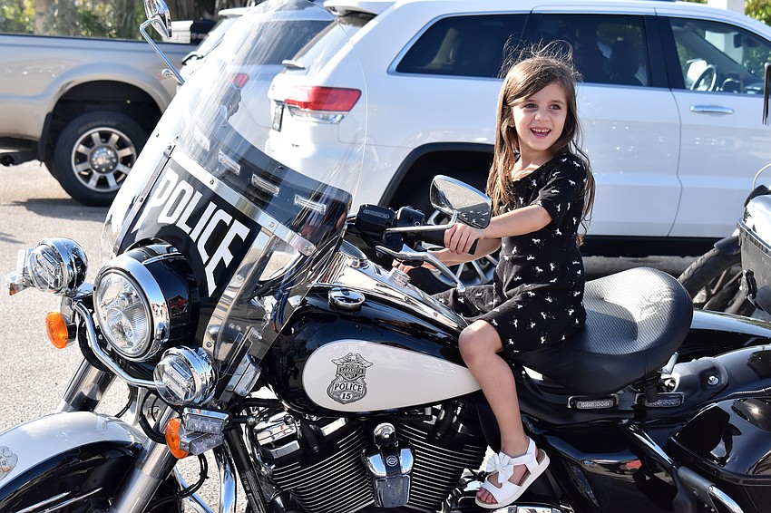 Emma Lindsey tests out a Sarasota Police Department motorcycle.