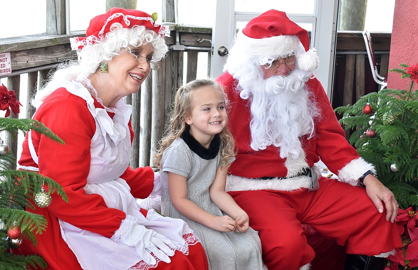 Ellie Turner visits with Santa and Mrs. Claus.