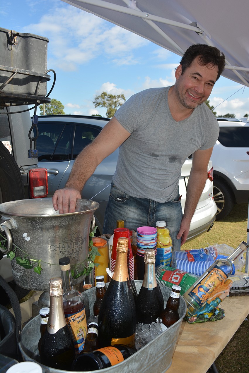 Heritage Harbour's Scott Ginn mans the bar during tailgating at the season opener.