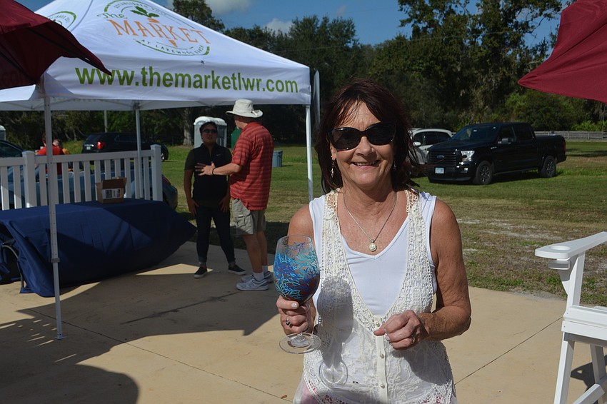 Sarasota's Anne Chase listens to the band One Night Rodeo before the polo match.