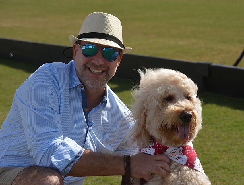 East County's David Liberatore takes his dog, Eddie, on a stroll across the polo field before the match.