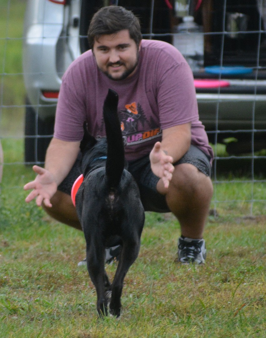 Sarasota's Landon Shoenberger greets Merlin after an impressive catch.
