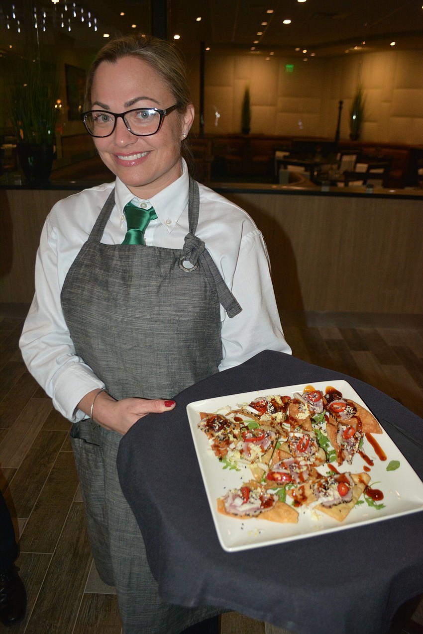 Waitress Sabrina Perry brings out seared ahi tuna nachos.