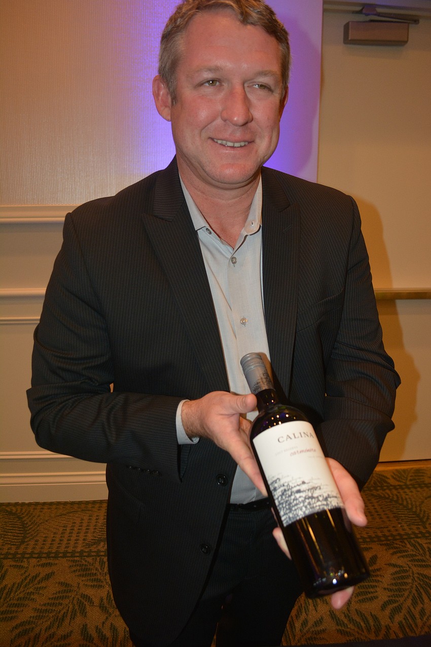 Craig Misja of Sarasota's Breakthru Beverage shows off a wine that will be available at the Grove.