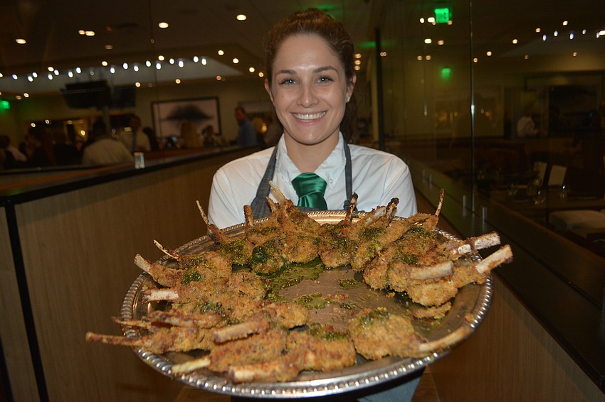 Alexis Bradford brings out a platter of lamb lollipop.