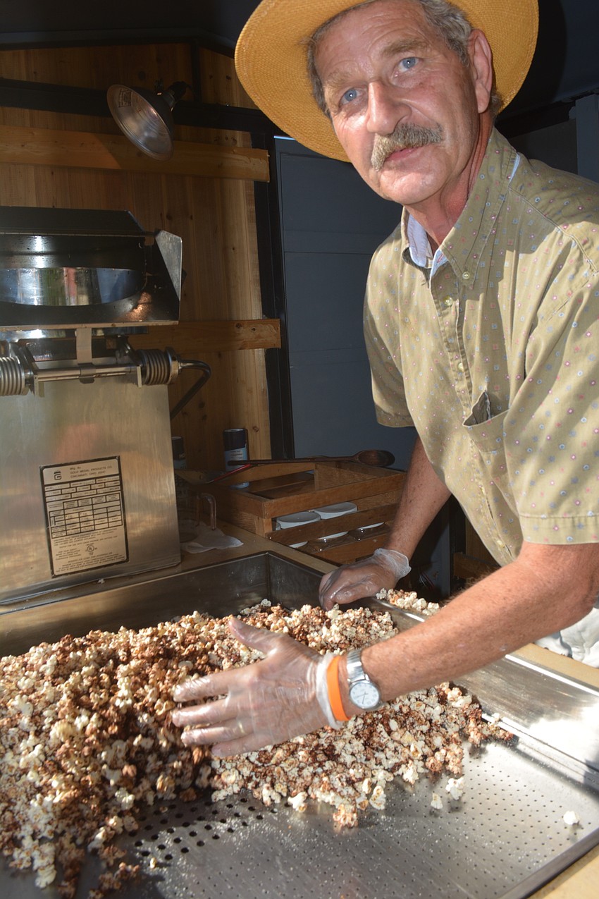 Phil Pagano of Uncle Phil's Healthy Snacks of Nokomis mixed a batch of his organic cinnamon popcorn.