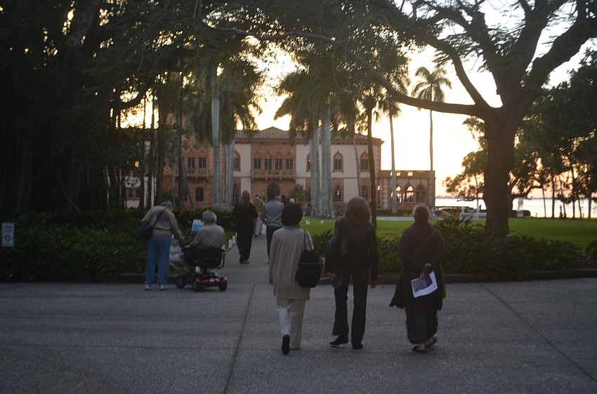 The sun sets behind the Ca' d'Zan House onto Sarasota Bay.