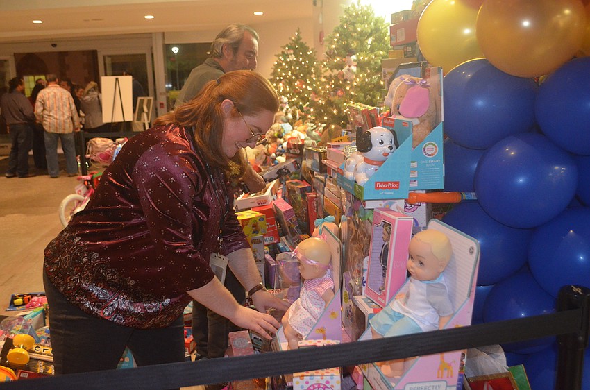 Courtney Robinson, a Ringling employee, stacks toys donated to the Toys for Tots.