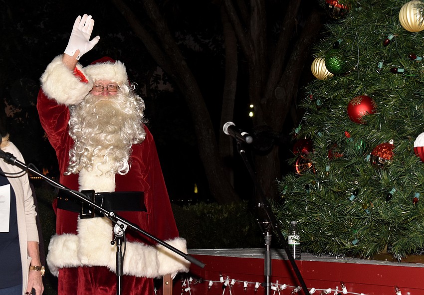 Santa Claus waves to the crowd before he lights the tree.