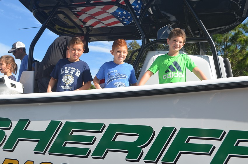 Jake Kostenchuk, Derek Kostenchuk and Andrew Moldovan aboard the sheriff's office marine unit.