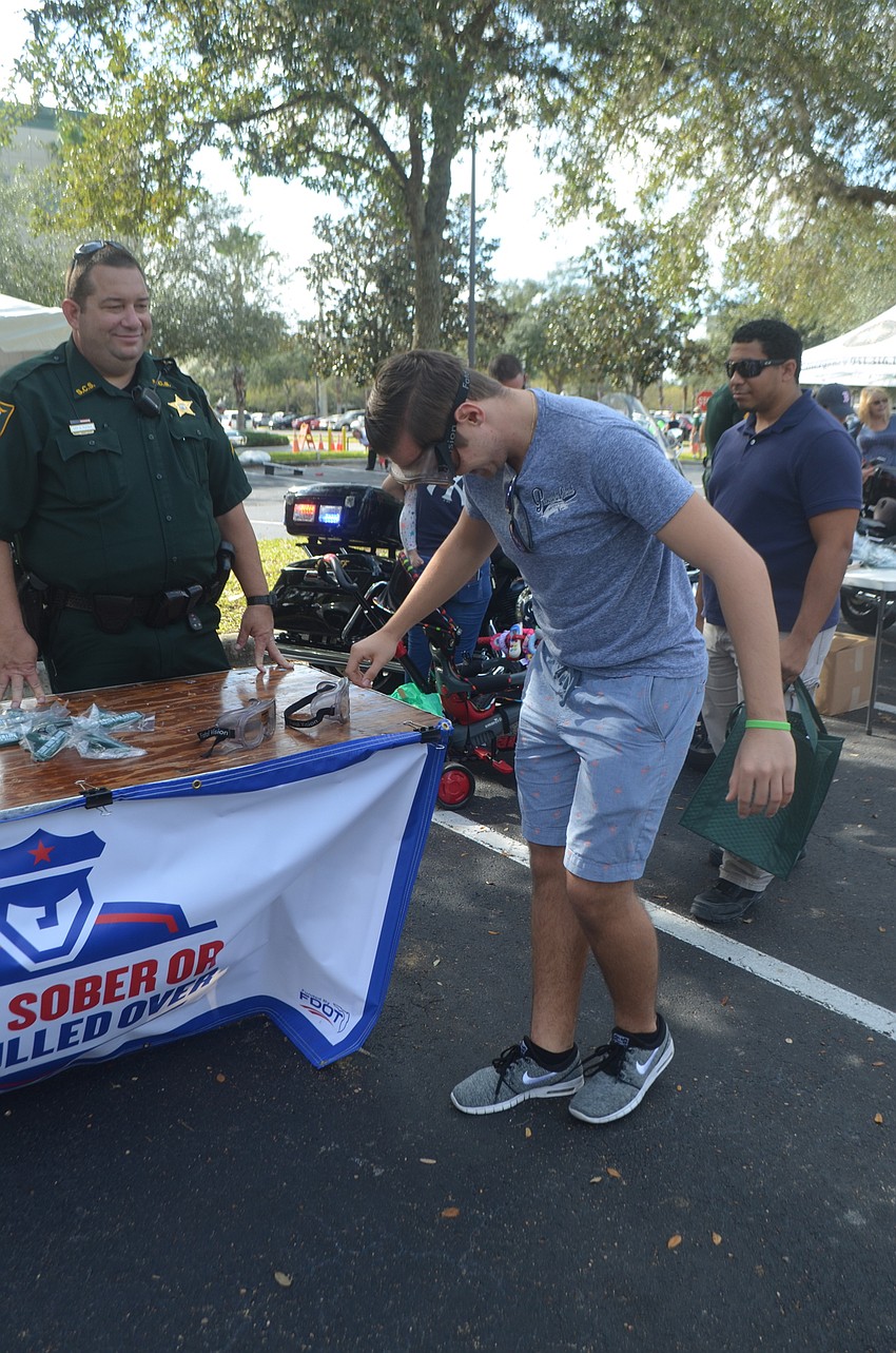 Mike Weiczorek tries on drunk goggles.