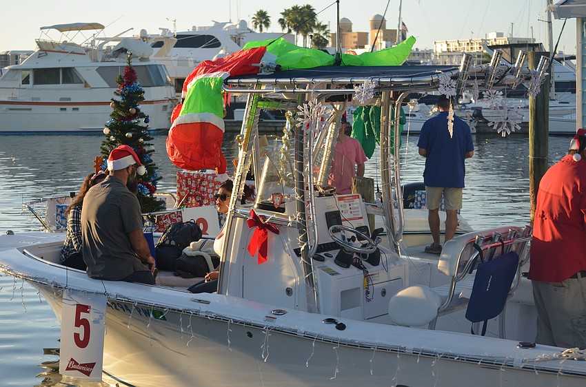 Boats were prepared for the parade in the marina by the Marina Jack restaurant.