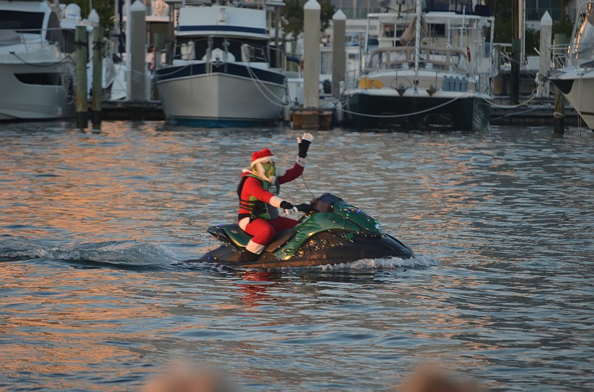 Someone dressed as the Grinch, riding around playing Christmas carols on a jetski.