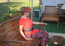 Mary Lynn Cheatham sits on a specialized wood made from white oak.