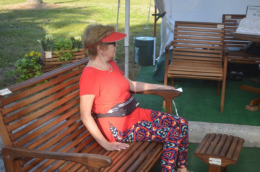 Mary Lynn Cheatham sits on a specialized wood made from white oak.