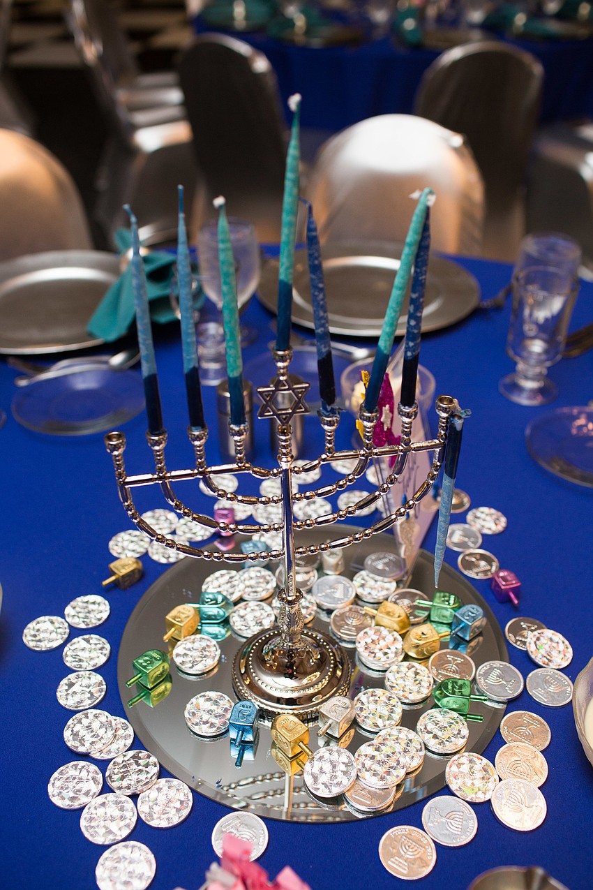 Menorahs and gelts centered the tables.
