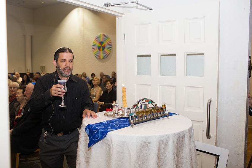Rabbi Michael Werbow presents the Havdallah and Lighting of the Hanukkah candles.