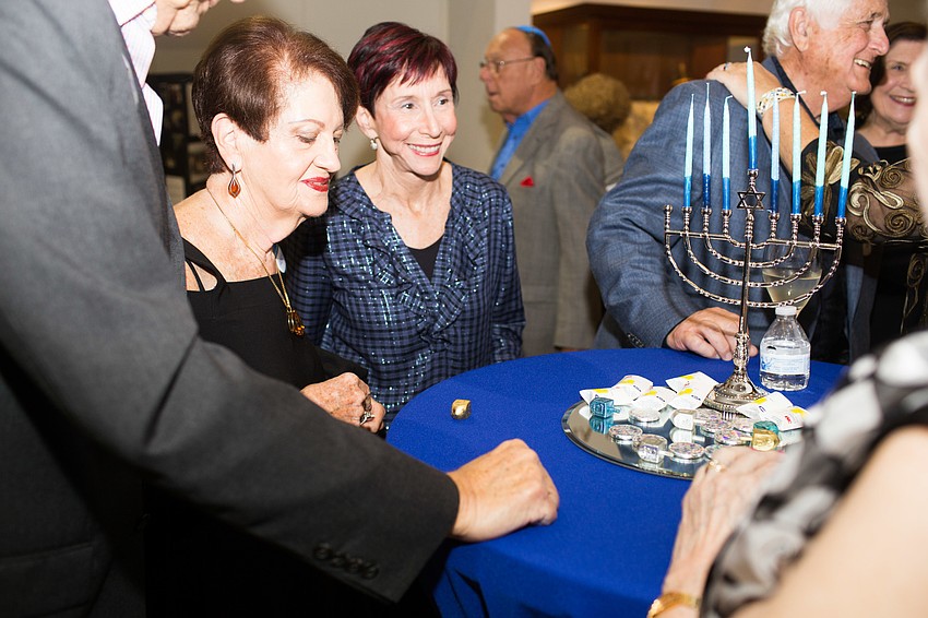 Guests play dreidel during social hour.