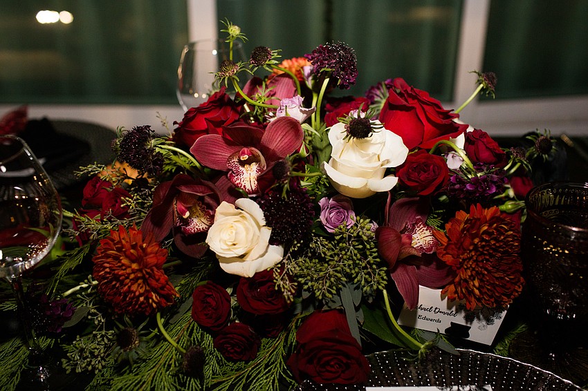 Dark moody flowers centered the tables.