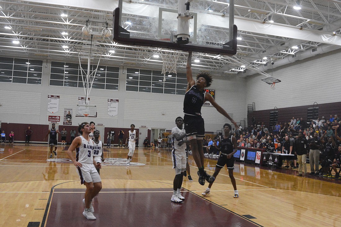 Booker&#39;s Johnnie Williams rattles the rim with a dunk in the final minute of the Tornadoes&#39; win against Riverview.