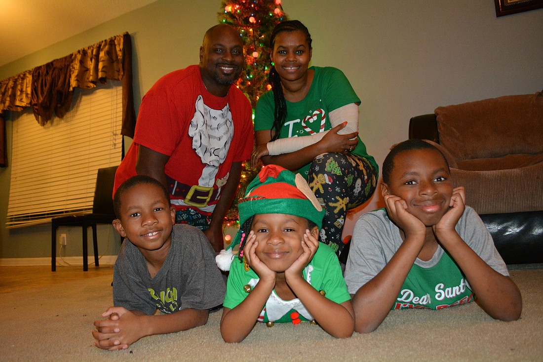 Each year, Patricia Christmas buys her family Christmas pajamas and T-shirts. Clockwise from bottom left are Elijah, Jermaine, Patricia, Tremaine and Genesys.
