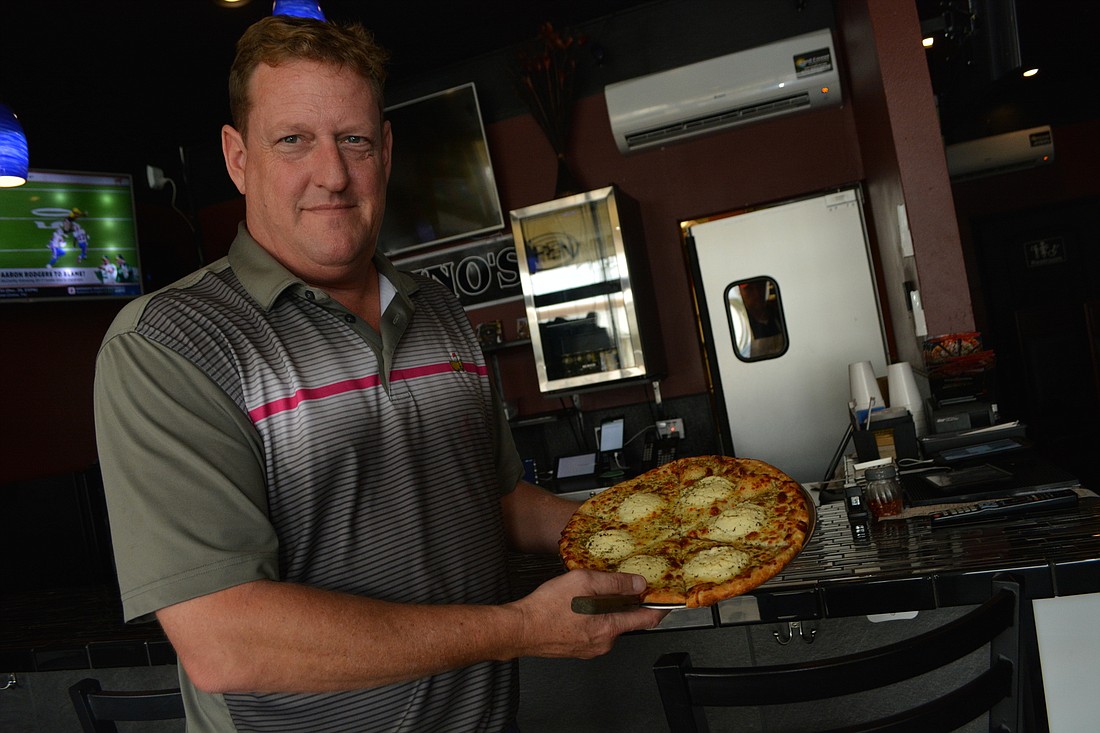 Santino&#39;s Gourmet Pizzeria, Italian Bistro & Pub owner John Cox enjoys meeting customers and seeing the enjoy the food.