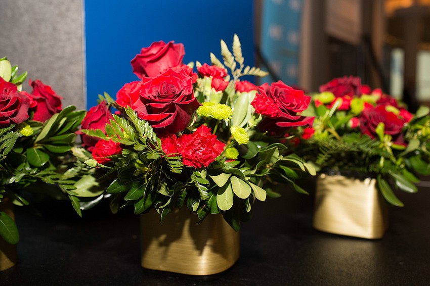 Roses centered each of the tables and the front podium.