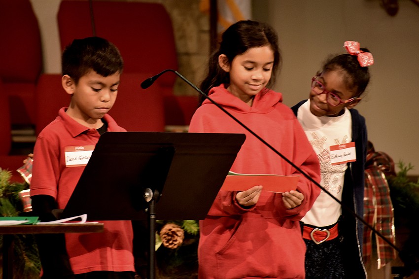 David Gonzalez, Amelie Hughes and Epiphany Randall recite a reading for the Christ Church members.