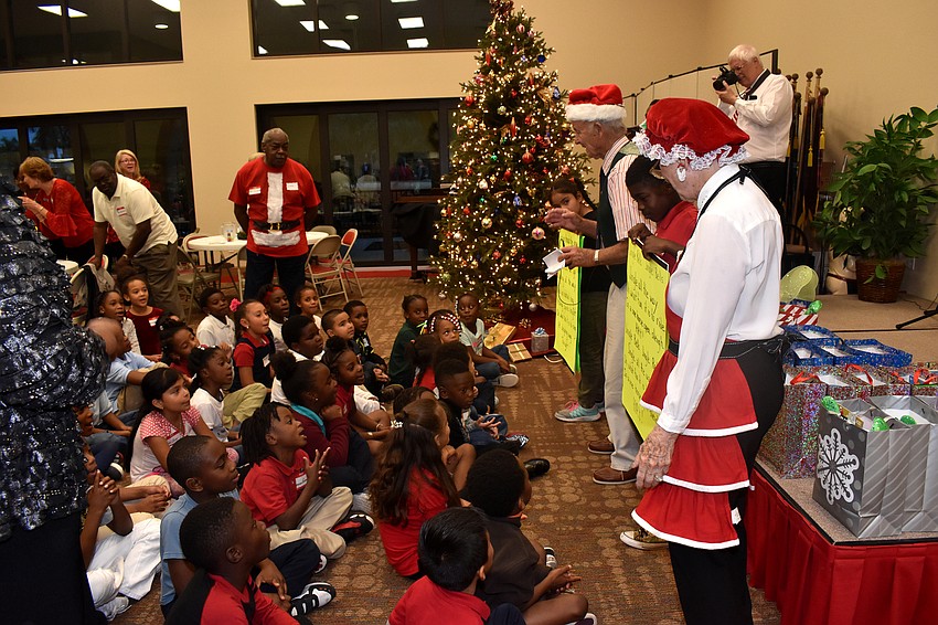 Students and Christ Church members sing Christmas carols to lure Santa to the party.