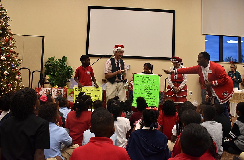 Students and Christ Church members sing Christmas carols to lure Santa to the party.