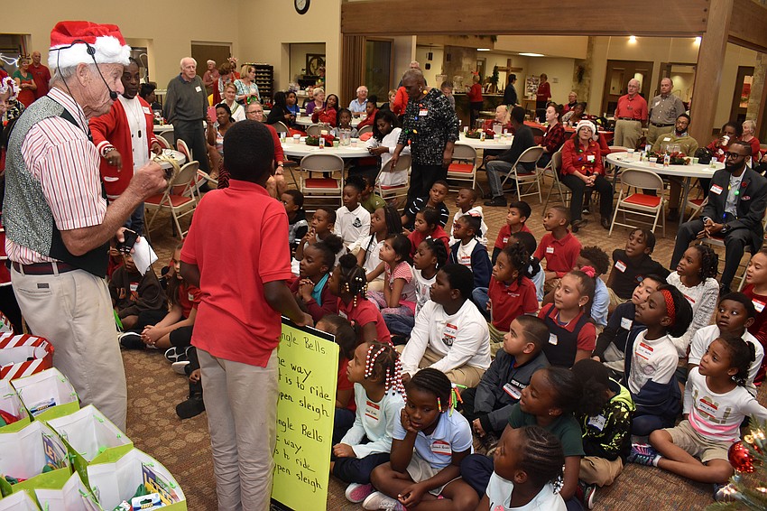 Students and Christ Church members sing Christmas carols to lure Santa to the party.