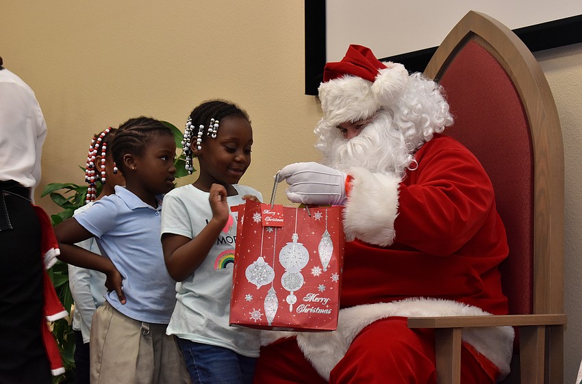 Draya Wilson is all smiles as she accepts a gift from Santa.