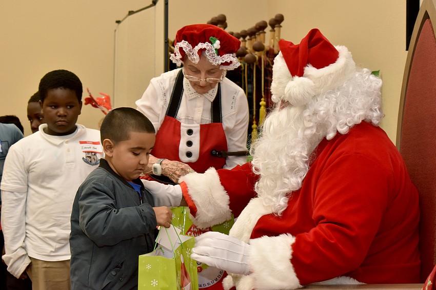 Guillermo Menses accepts a gift from Santa.