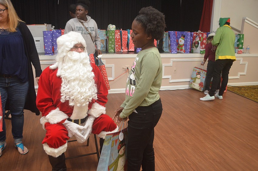Angelique Williams tells Santa what she wants for Christmas.