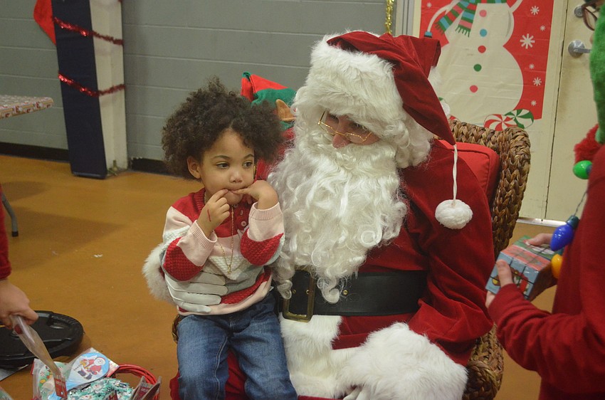 Deniyla Brown tells Santa Claus what she wants for Christmas this year.