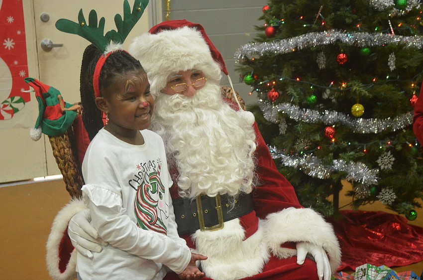 Amani Carter poses for a picture with Santa.