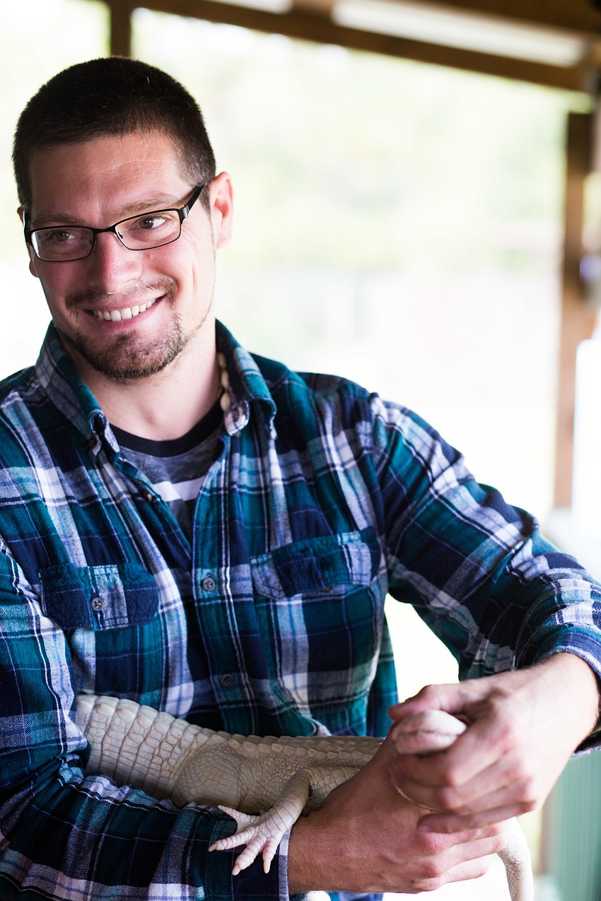 Mike Caruthers shows guests his alligator.