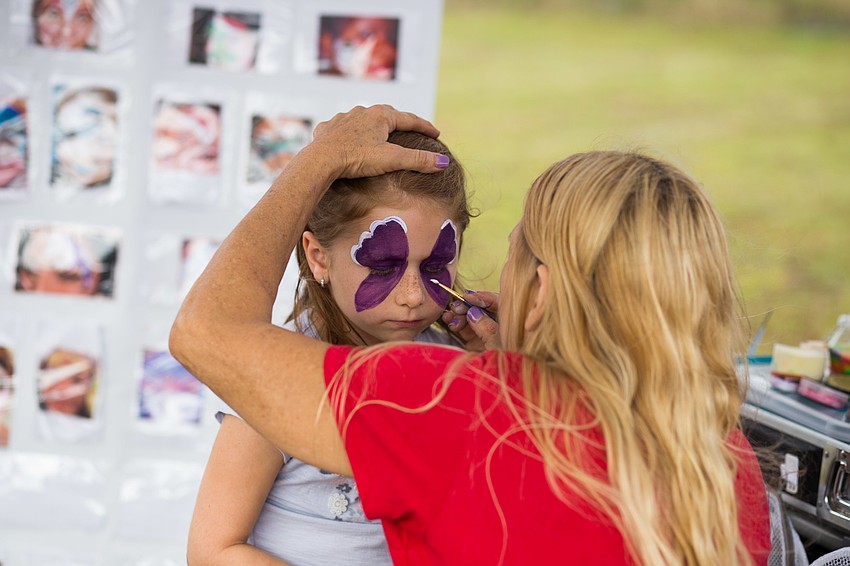 Aubriana Elwell gets her face painted.