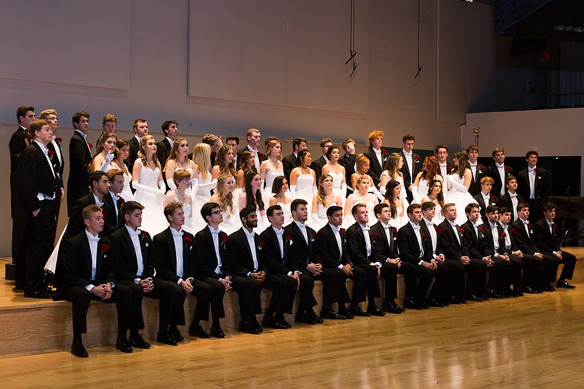The debutantes and their escorts line up for a photo.