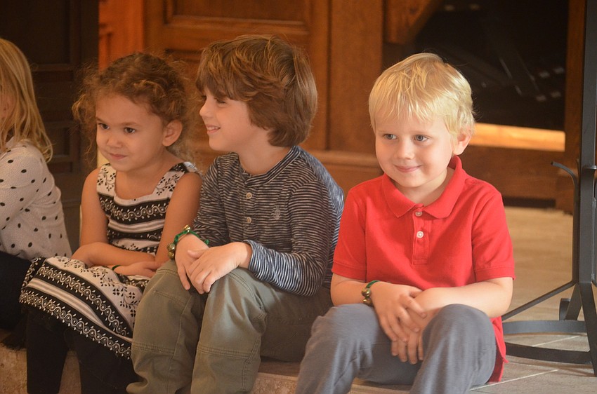 Hawley Holesbeke, Ethan Winsler and Payton Netting get their pictures taken by their parents before the program starts.