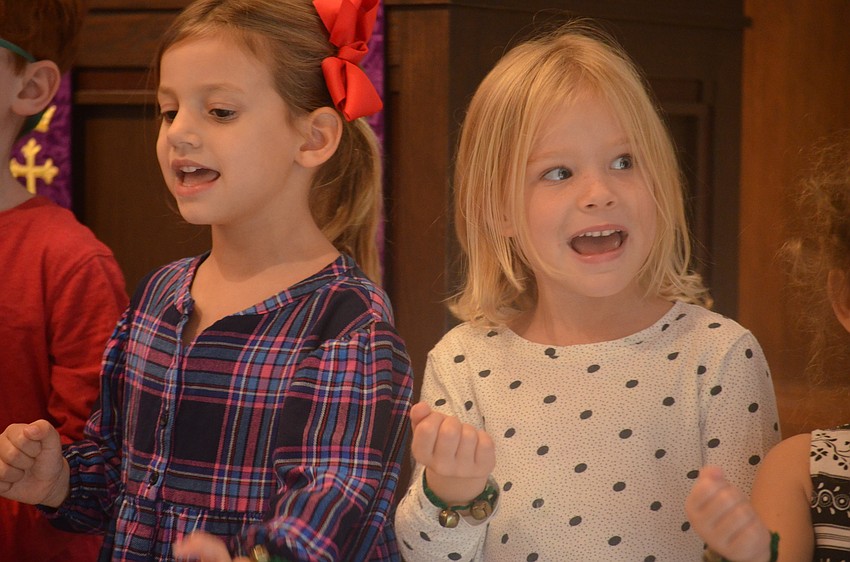 Ayla Robins and Madeline Leaf practiced with the rest of their class before they participated in the Christmas program.