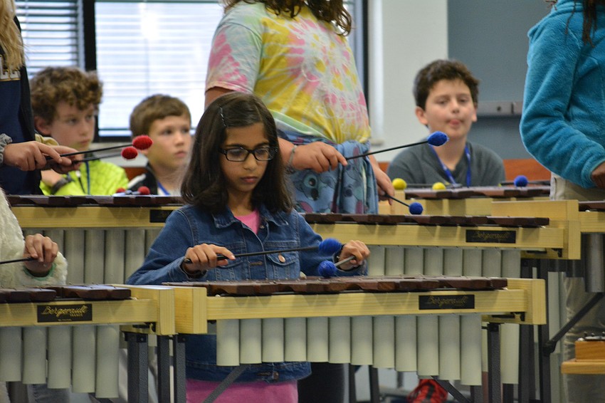Fifth-grader Kiran Kalia plays the xylophone.