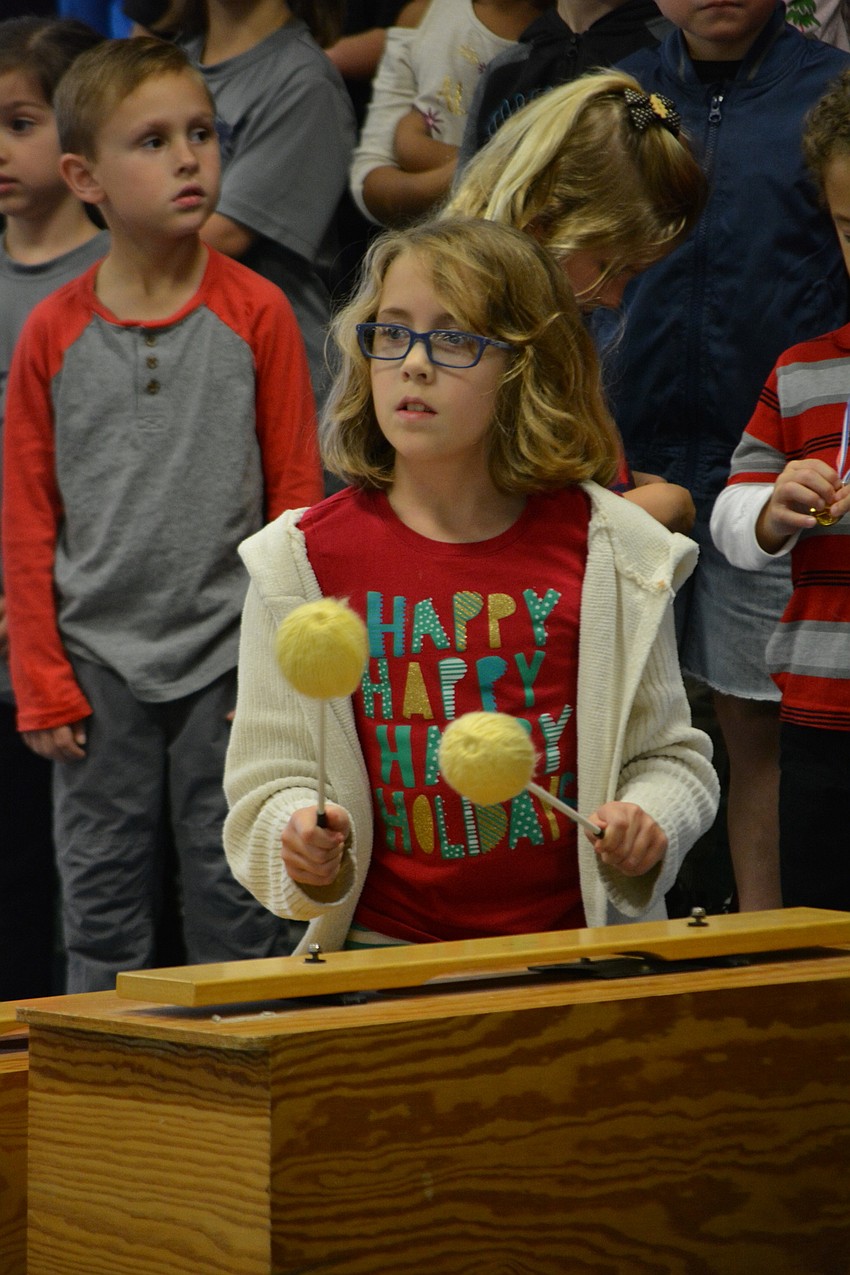 Fourth-grader Madelyn Gabriel  plays a song about Chanukah.