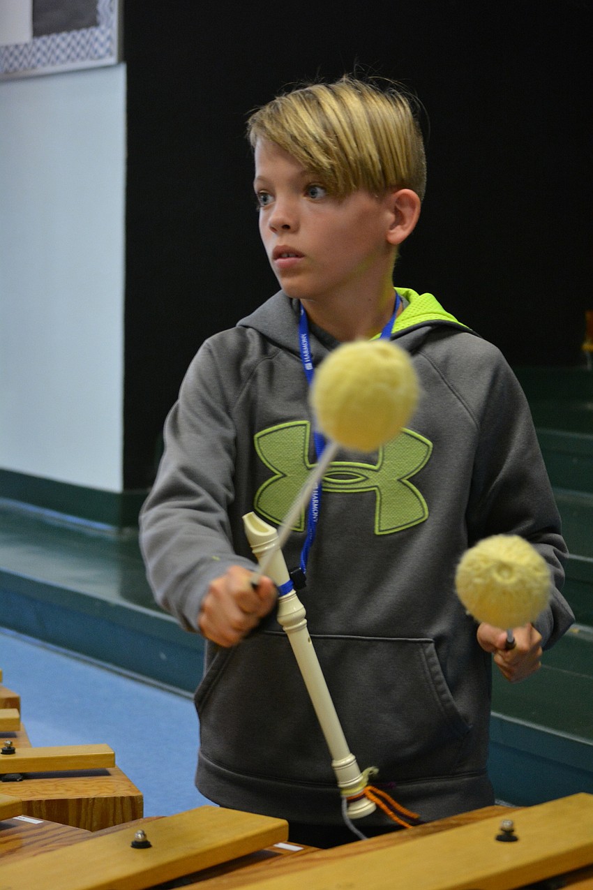 Cooper Flammang drums during a song about Sneezy, the Snowman.