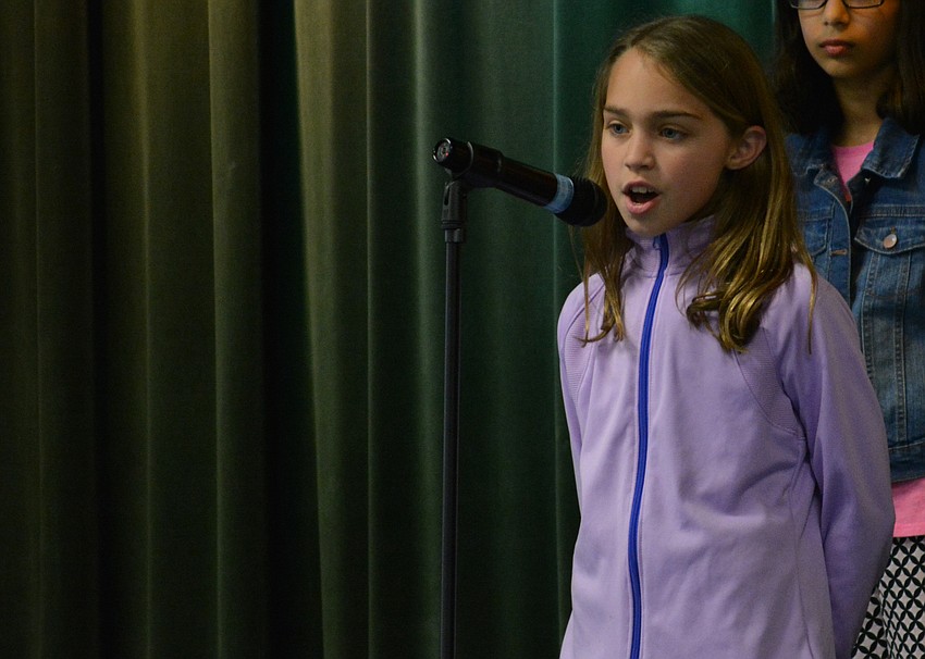 Skyla Bermann performs a solo during Cantissimas Choir performance of  