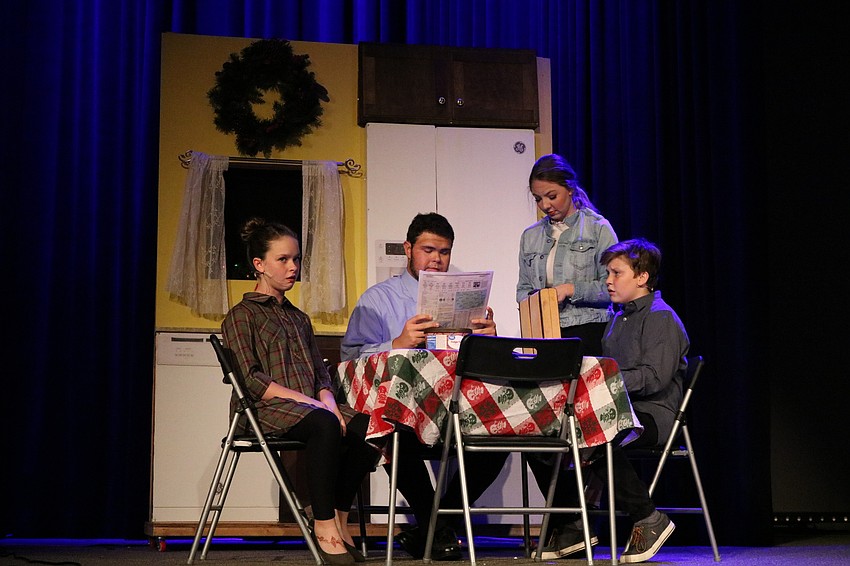 Sophia Clauson, Dan Osborne, Anna Landis and Seth Pisani  play the lead family, the Bradleys. They discuss how Mrs. Bradley has been assigned to direct the church's Christmas pageant. Photo by Debby Hradek.