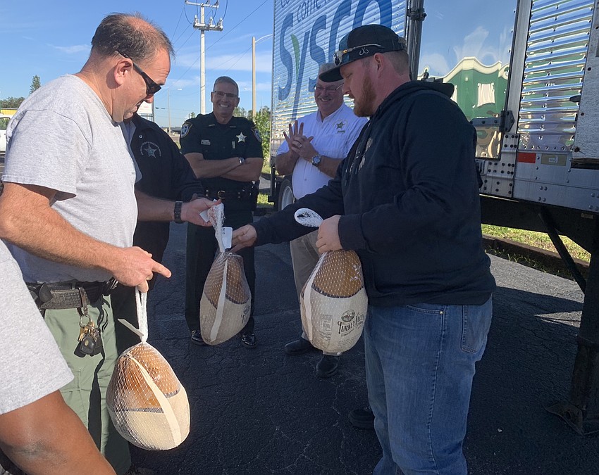 Some first responders grabbed more than one turkey, like Deputy Eric Bault who grabbed a turkey from Zach Quattlebaum.
