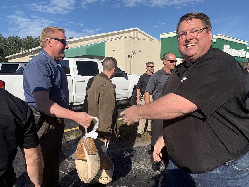 Deputy Brian Moreland picked up a turkey from Chris Quattlebaum early in the morning.
